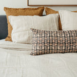 Peachy Floral Kantha Quilted Lumbar Pillow Shown On Bed