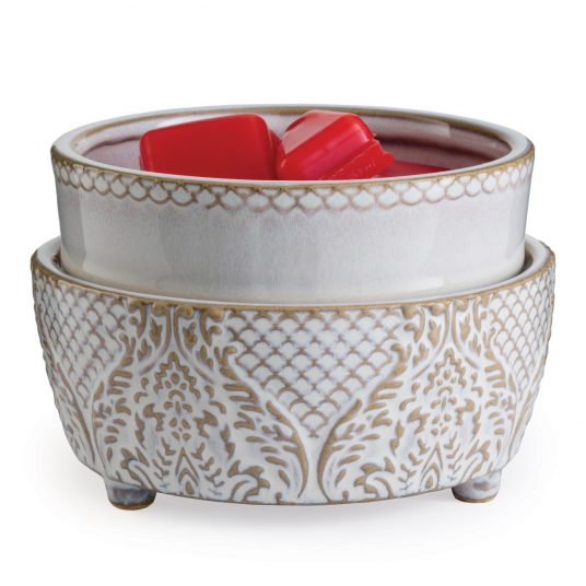 Decorative ceramic bowl with red wax melts on a white background
